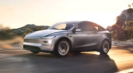 2026-tesla-model-y-silver-front-angled-view-driving.jpg