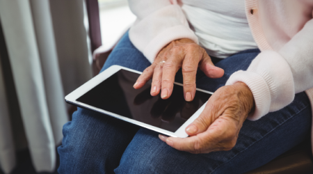 Old-woman-using-digital-tablet.png