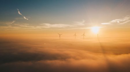 a-group-of-windmills-in-the-sky-above-the-clouds.jpg