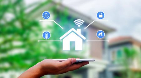 hands-holding-smart-phone-with-app-smart-home-on-blurred-house-as-backgrounds.jpg