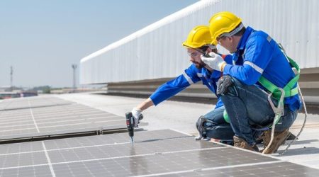 men_fitting_solar_panels_on_retrofit_building_smart_cities_Adobe1_rt.jpg