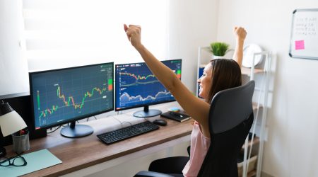 person-looking-at-graphs-and-charts-happy-because-the-stock-market-went-up.jpg